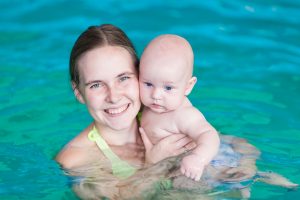 37774635 - mother with baby in swimming pool training